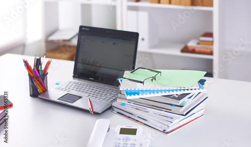 Workplace with notebook laptop Comfortable work table in office windows and city view