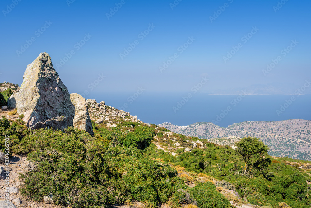 Green mountain coast view to the greek blue sea with crystal clear water over high hills mountains to small village volcano edge perfect for hiking relaxing, Nisyros Island, Kos, Dodecanese, Greece