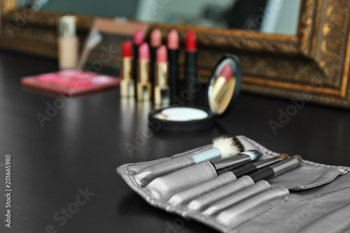 Brushes on dressing table in makeup room, closeup