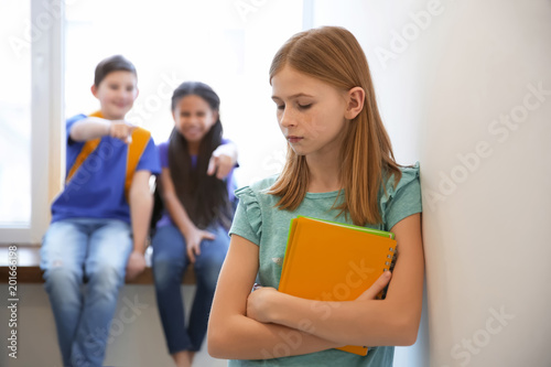 Sad teenage girl indoors. Bullying in school