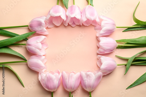 Fototapeta Naklejka Na Ścianę i Meble -  Beautiful frame made of tulips for Mother's Day on color background