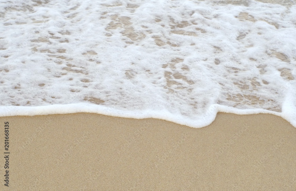 The white waves bounce up to the fine sand. The white waves bounce up to the fine sand.