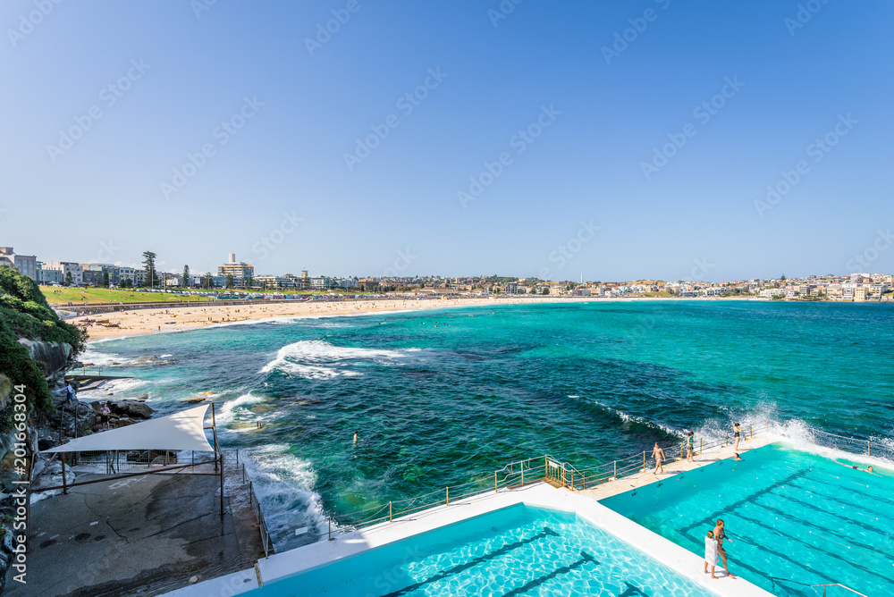 Sunny beautiful summer coast view to the famous sandy Bondi Beach and blue Tasman Sea with great waves perfect for surfing or swimming in pools, relax, Bondi Beach, Sydney, NSW/ Australia - 10 12 2017
