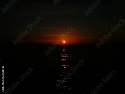 Sun goes to the Black sea. Sunset with reflection