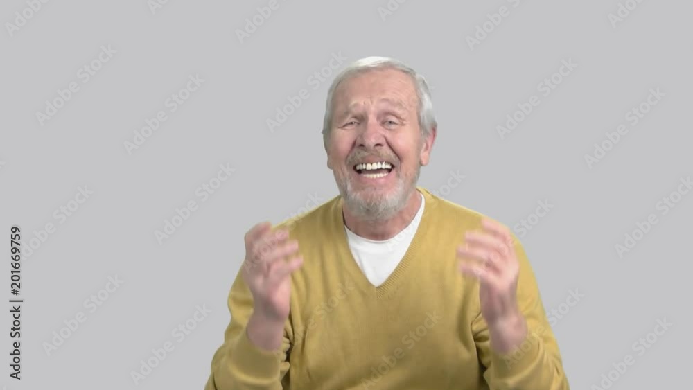 Elderly desperate man, grey background. Senior man in deep despair, slow motion. Human emotions of sorrow and frustration. Elderly desperate man, grey background. Senior man in deep despair, slow motion. Human emotions of sorrow and frustration.