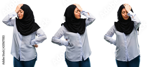 Arab woman wearing hijab stressful keeping hand on head, tired and frustrated isolated over white background
