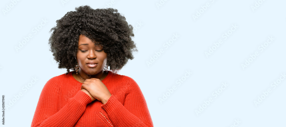 Beautiful african woman crying depressed full of sadness expressing sad emotion, blue background Beautiful african woman crying depressed full of sadness expressing sad emotion, blue background