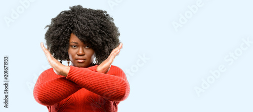Slika na platnu Beautiful african woman annoyed with bad attitude making stop sign crossing hand