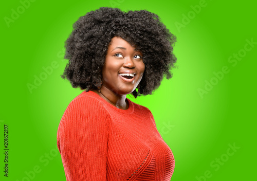 Beautiful african woman happy and surprised cheering expressing wow gesture