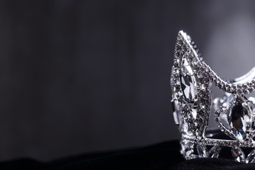 Diamond Silver Crown for Miss Pageant Beauty queen Contest, Crystal Tiara jewelry decorated gems stone and abstract dark background on black velvet fabric cloth, Macro photography copy space