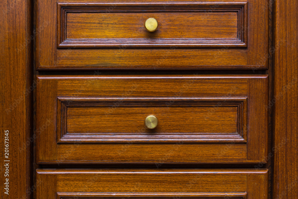 Front showcase cabinet or wardrobe wooden frame door and drawers made from dark wood, background and texture. Front showcase cabinet or wardrobe wooden frame door and drawers made from dark wood, background and texture.