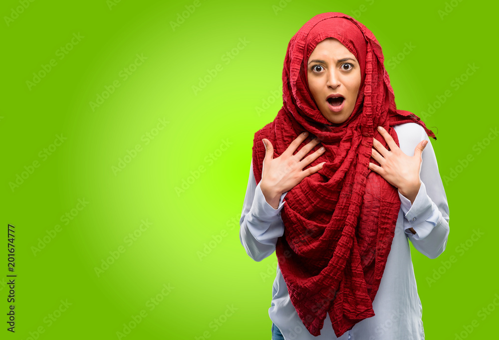 Young arab woman wearing hijab happy and surprised cheering expressing wow gesture Young arab woman wearing hijab happy and surprised cheering expressing wow gesture