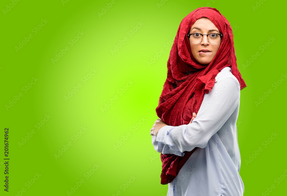 Young arab woman wearing hijab nervous and scared biting lips looking camera with impatient expression, pensive Young arab woman wearing hijab nervous and scared biting lips looking camera with impatient expression, pensive