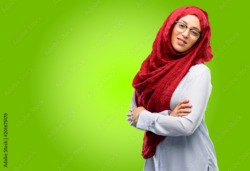 Young arab woman wearing hijab confident and happy with a big natural smile laughing, natural expression Young arab woman wearing hijab confident and happy with a big natural smile laughing, natural expression
