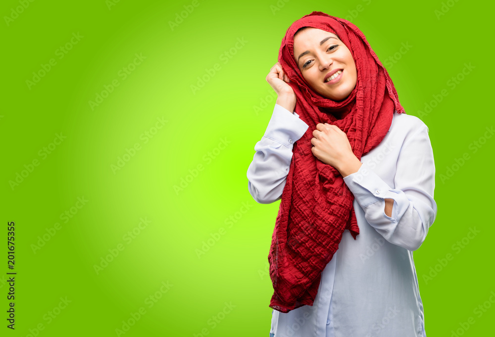 Young arab woman wearing hijab confident and happy with a big natural smile laughing Young arab woman wearing hijab confident and happy with a big natural smile laughing