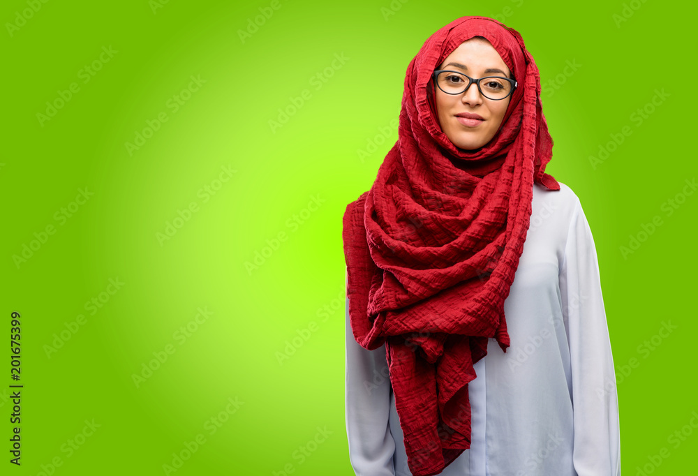 Young arab woman wearing hijab confident and happy with a big natural smile laughing Young arab woman wearing hijab confident and happy with a big natural smile laughing