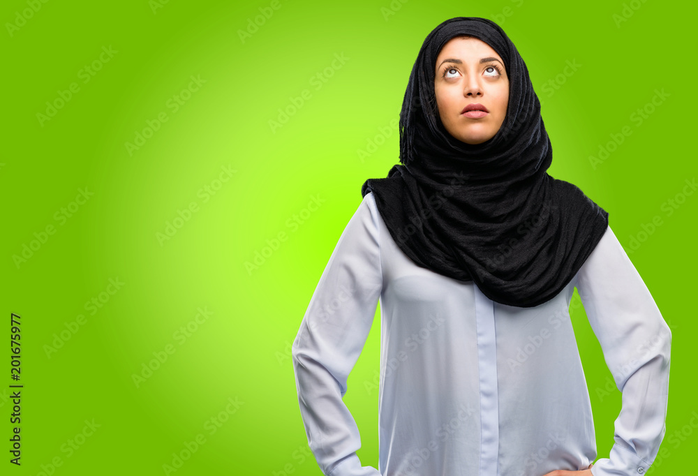 Young arab woman wearing hijab confident and happy with a big natural smile laughing Young arab woman wearing hijab confident and happy with a big natural smile laughing
