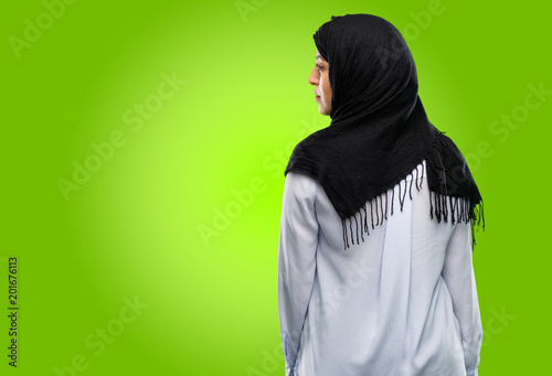 Young arab woman wearing hijab backside, rear view