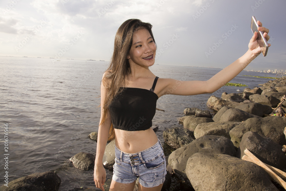 Teen Filipina Selfie by The Ocean Stock Photo Adobe Stock