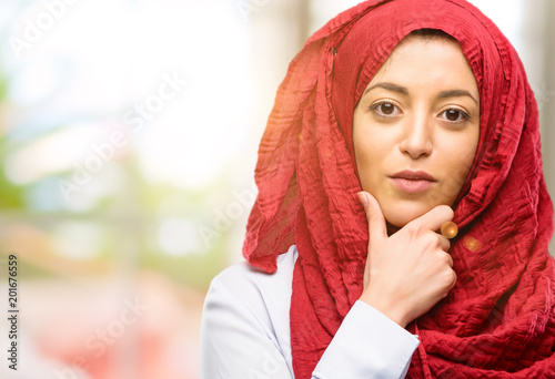 Young arab woman wearing hijab thinking thoughtful with smart face