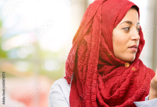 Young arab woman wearing hijab with crossed arms confident and serious © Krakenimages.com