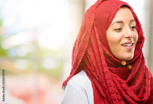Young arab woman wearing hijab confident and happy with a big natural smile laughing