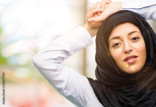 Young arab woman wearing hijab confident and happy with a big natural smile