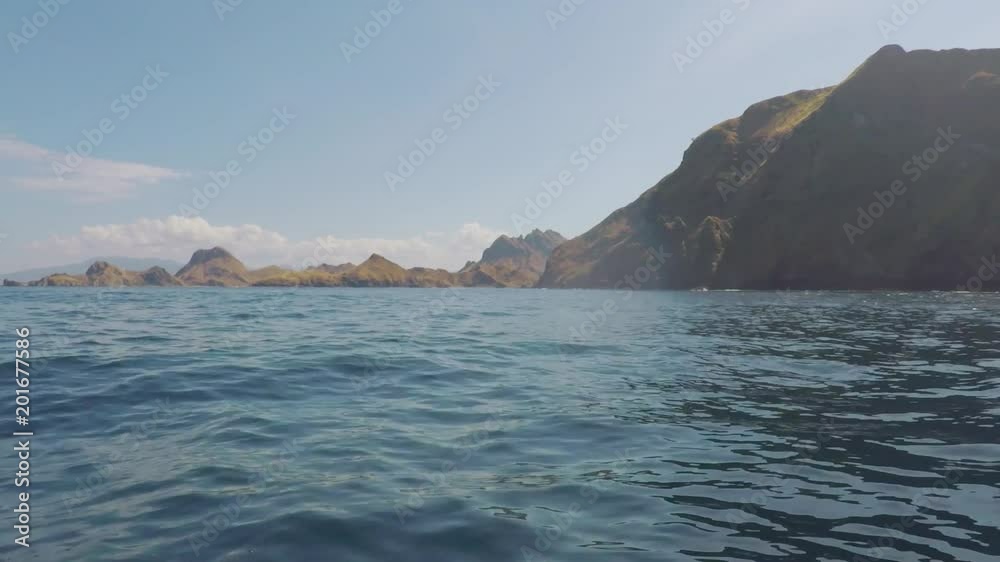 Beautiful tropical island landscape from a boat moving to Komodo Island, East Nusa Tenggara, Indonesia Beautiful tropical island landscape from a boat moving to Komodo Island, East Nusa Tenggara, Indonesia