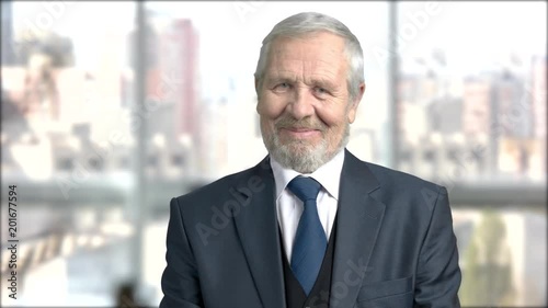 Flirtatious aged businessman, blurred background. Elderly executive flirting with eyes on window city background. Invitation for a date. Ogle mature businessman.