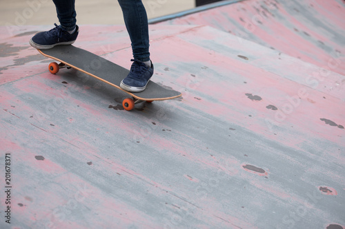 Skateboarder sakteboarding on skatepark ramp © lzf
