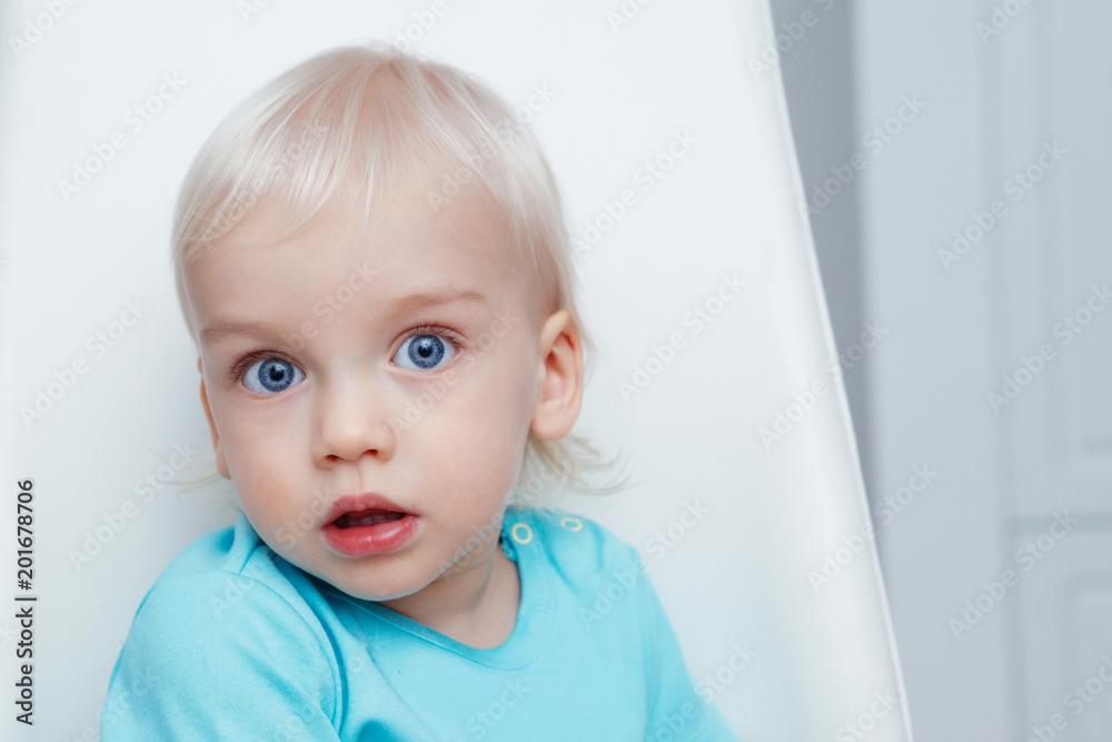 Cute boy with blond hair and blue eyes