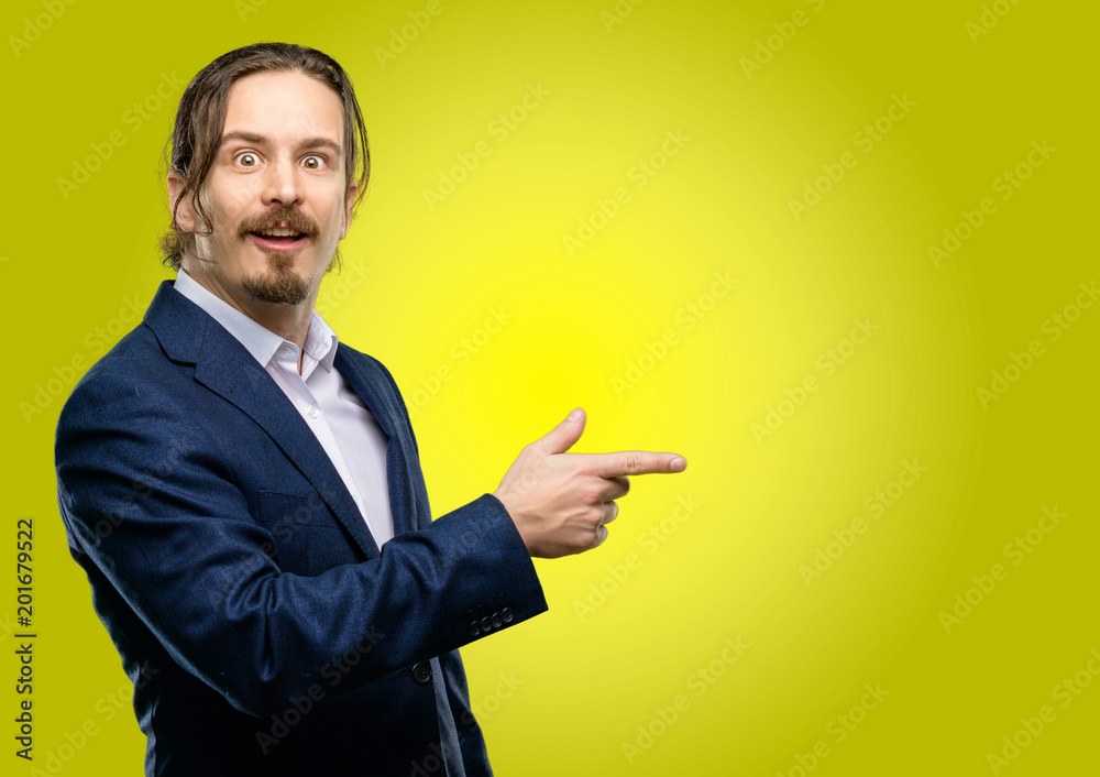 Handsome young man pointing away side with finger Handsome young man pointing away side with finger