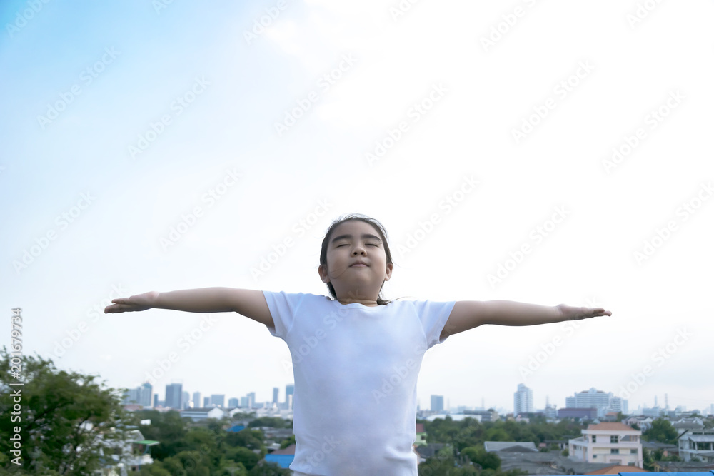 Little girl closed her eyes and breathing with fresh blowing air. Little girl closed her eyes and breathing with fresh blowing air.