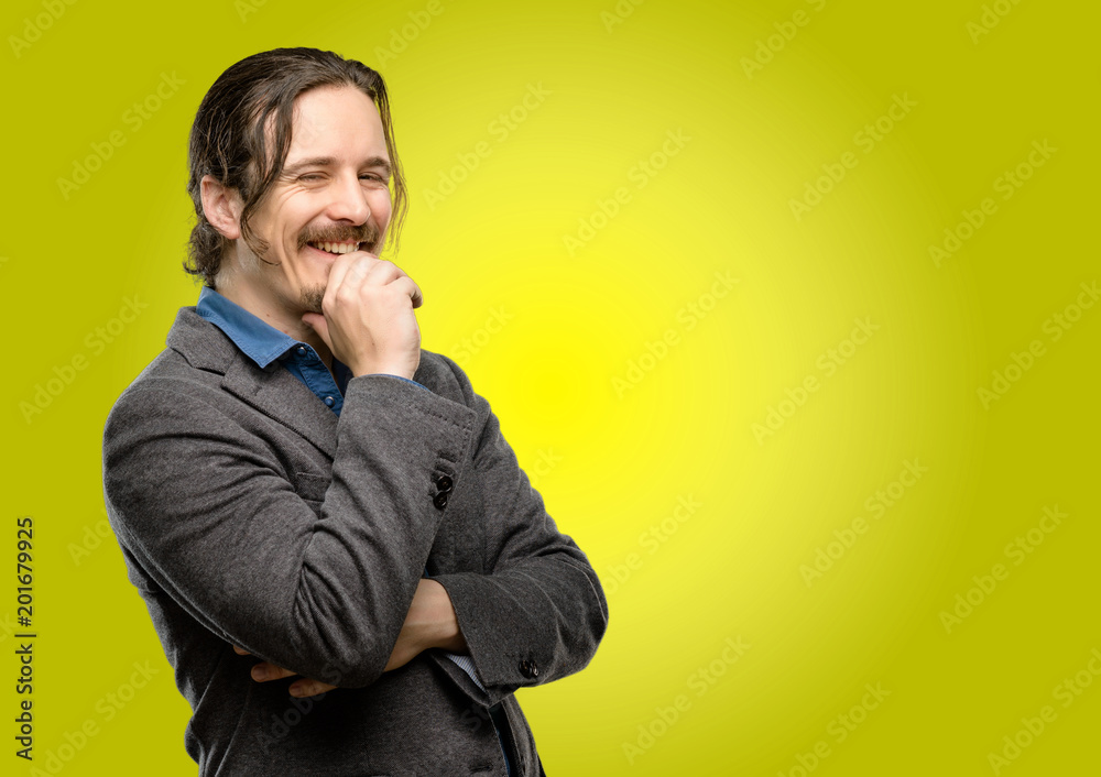 Handsome young man confident and happy with a big natural smile laughing