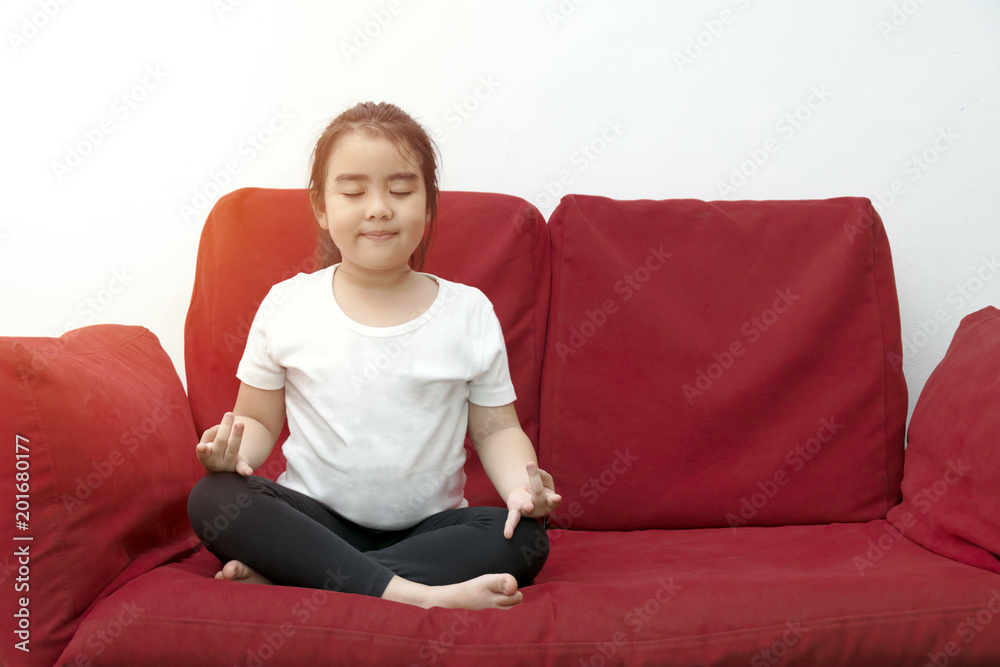 yoga hands of Asia Girl doing meditation,Sitting on red sofa. yoga hands of Asia Girl doing meditation,Sitting on red sofa.