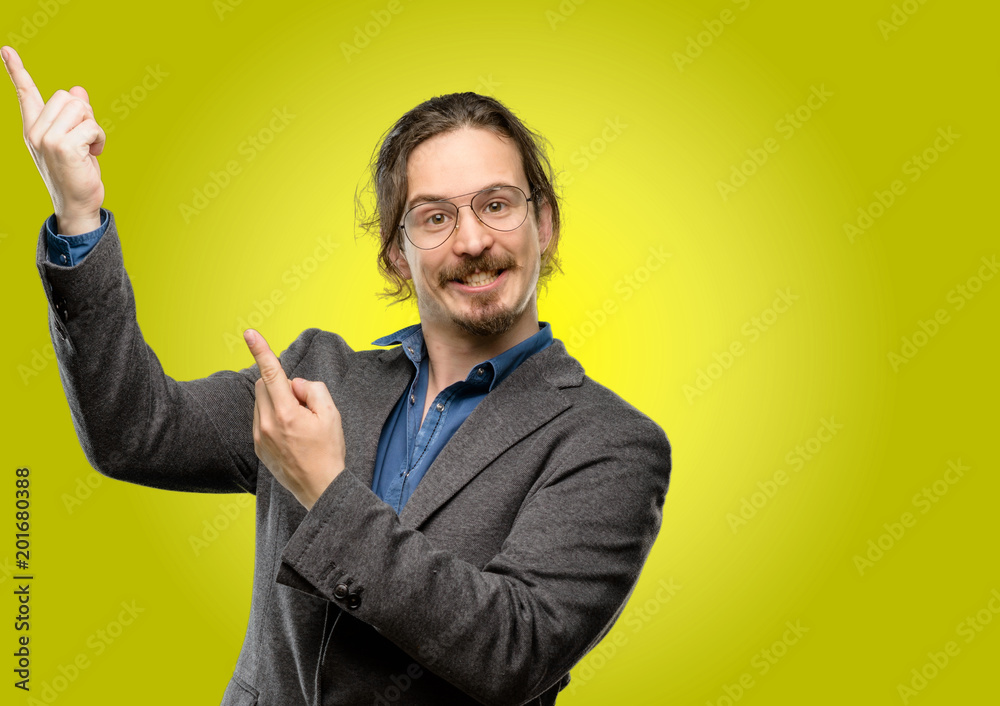 Handsome young man pointing away side with his finger Handsome young man pointing away side with his finger