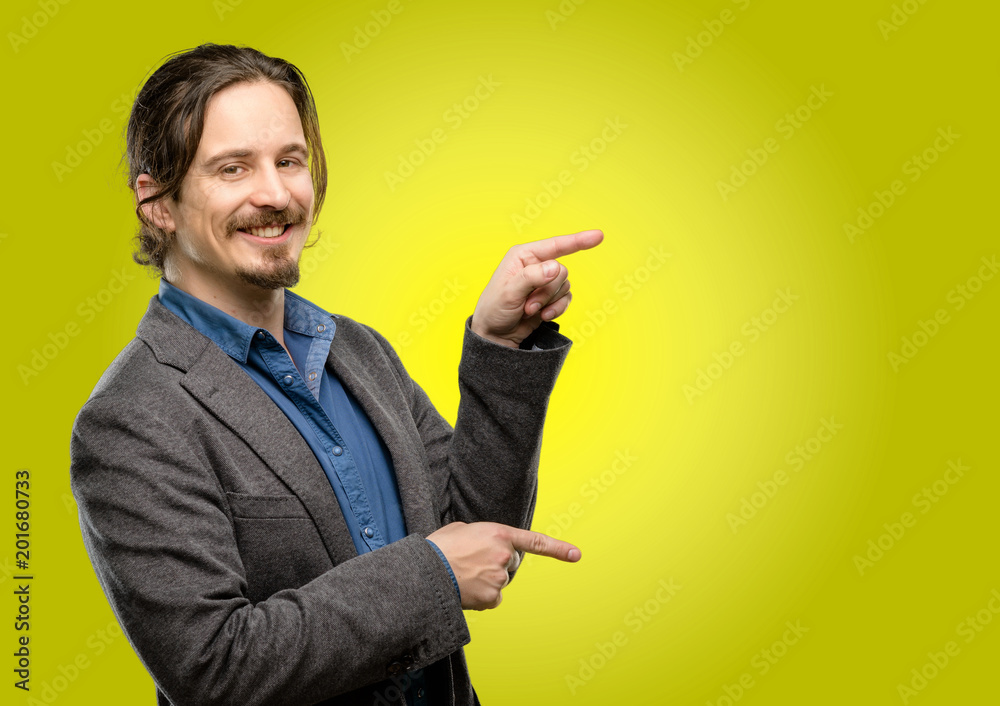 Handsome young man pointing away side with finger Handsome young man pointing away side with finger