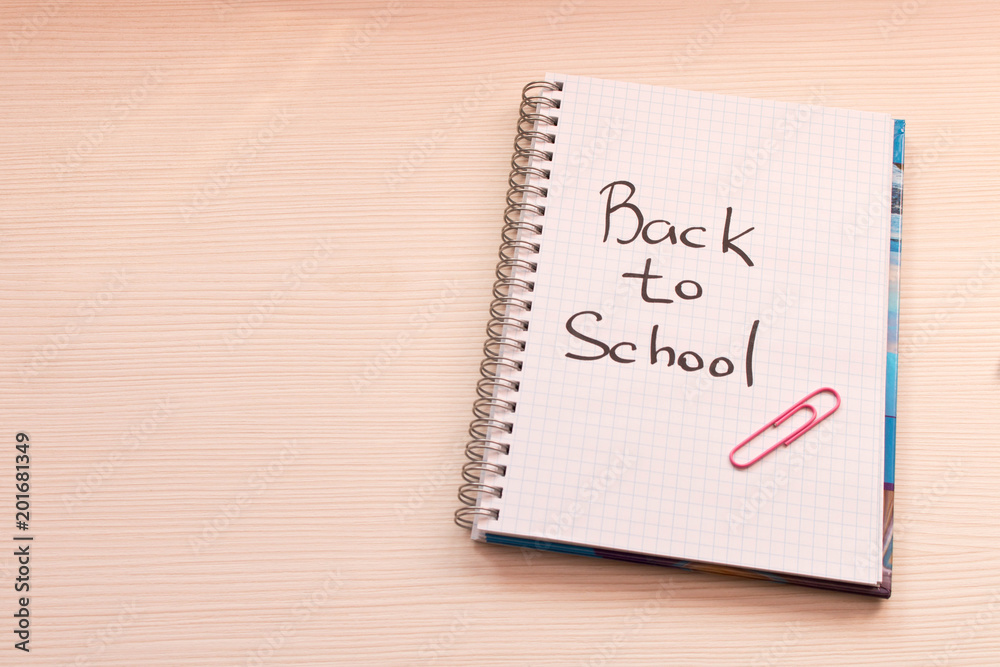 Notebook with the inscription back to school on the Desk . School concept Notebook with the inscription back to school on the Desk . School concept