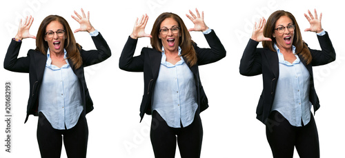 Middle age business woman happy and surprised cheering expressing wow gesture over white background