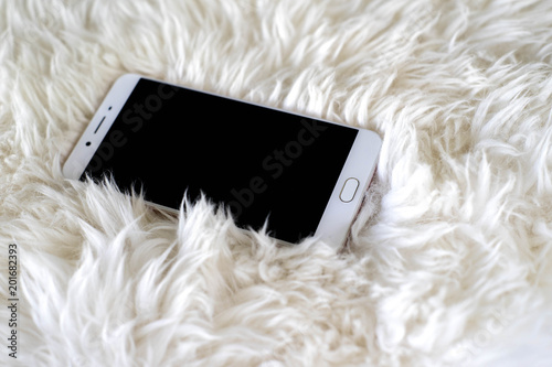 Smart phone on white carpet