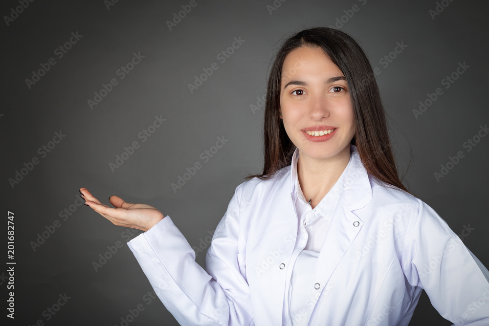 Turkish beautiful smiling young girl in doctor or chef clothes and empty tray pose Turkish beautiful smiling young girl in doctor or chef clothes and empty tray pose