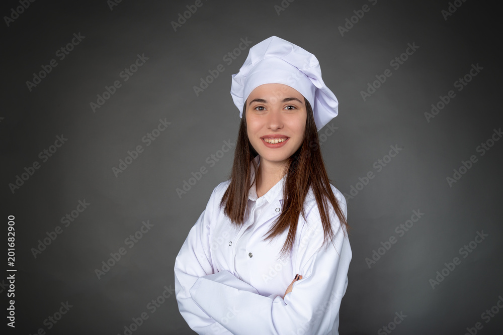 Beautiful Turkish smiling young female chef with confident expression Beautiful Turkish smiling young female chef with confident expression