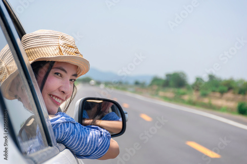 Woman drive a car on the road with a mountain