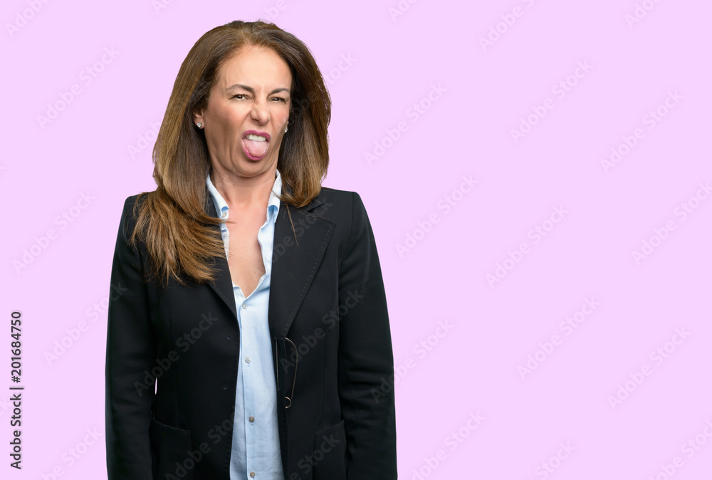 Middle age business woman feeling disgusted with tongue out Middle age business woman feeling disgusted with tongue out