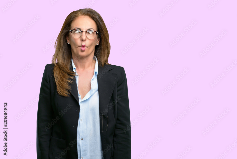 Middle age business woman making funny face fooling Middle age business woman making funny face fooling