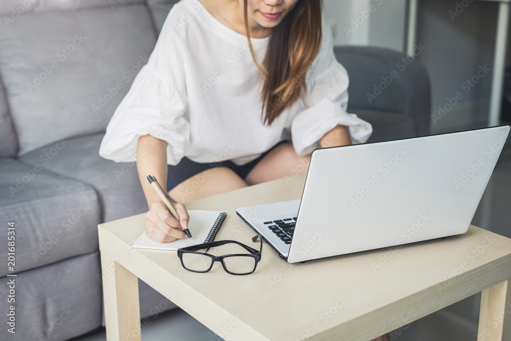 Young woman using laptop on sofa at home Young woman using laptop on sofa at home