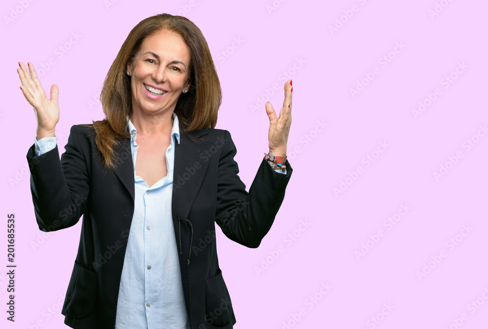 Middle age business woman confident and happy with a big natural smile welcome gesture Middle age business woman confident and happy with a big natural smile welcome gesture