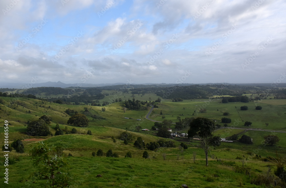 Broad panorama of the countryside in North New South Wales with green fields. Grassy hills in Australia. View from Minyon Falls lookout, Nightcap National Park.