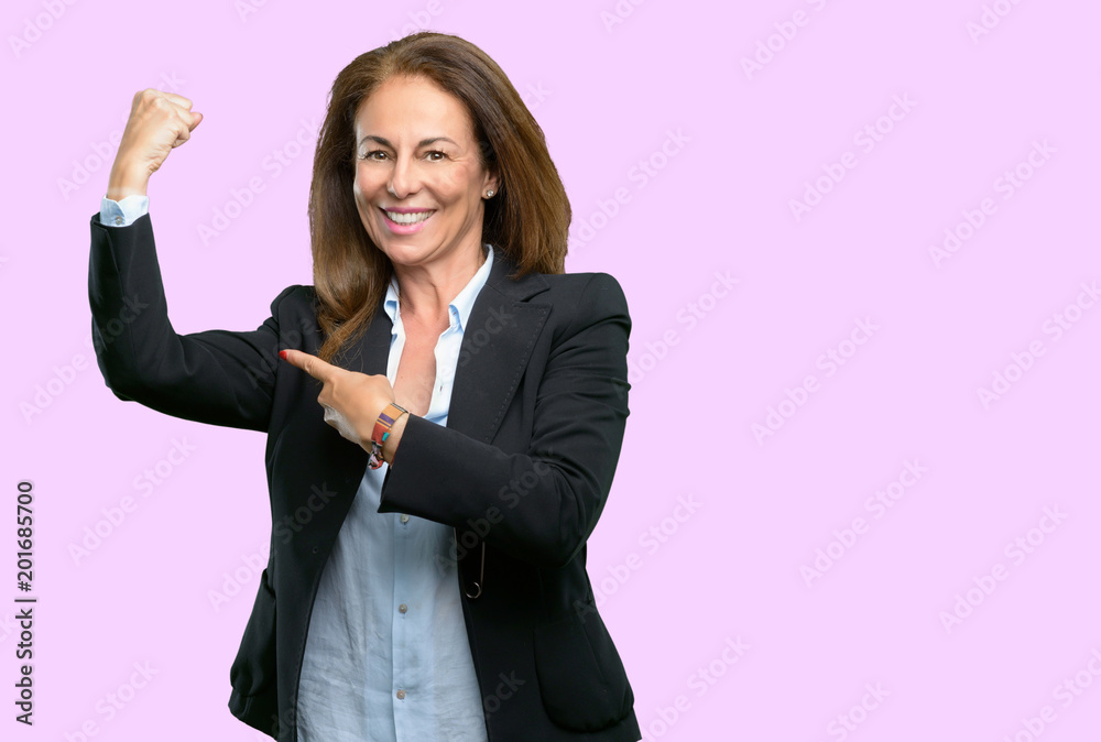 Middle age business woman pointing biceps expressing strength and gym concept, healthy life its good Middle age business woman pointing biceps expressing strength and gym concept, healthy life its good