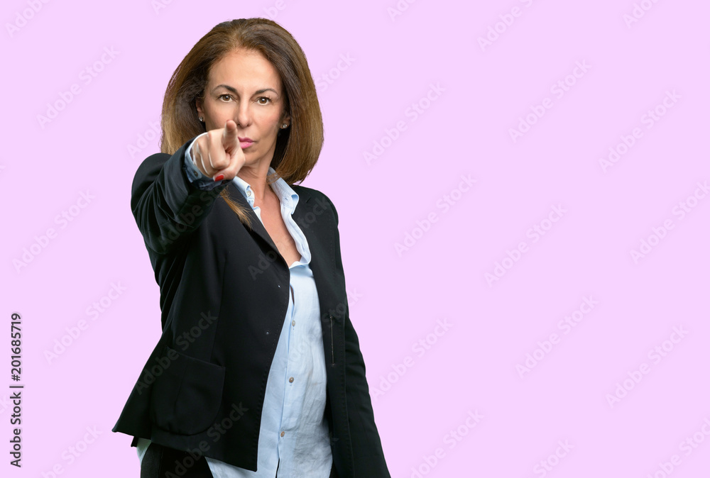 Middle age business woman pointing to the front with finger Middle age business woman pointing to the front with finger